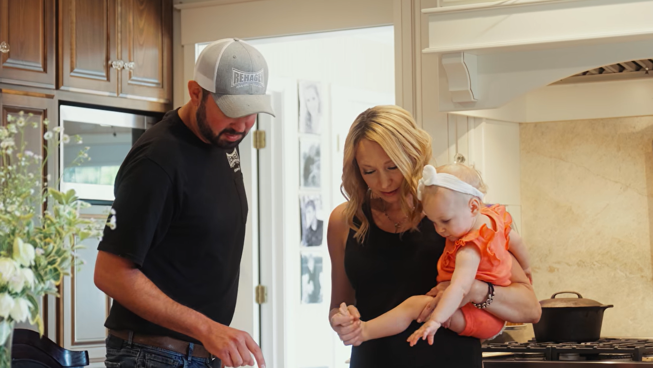 A friendly HVAC technician consulting with a homeowner in their living room, pointing to a heating system brochure - heating installation jefferson city